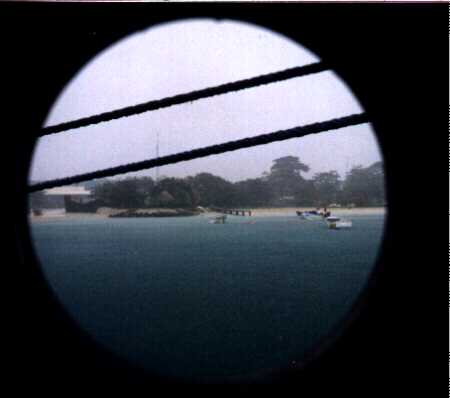 The beach during a storm, seen through a port-hole