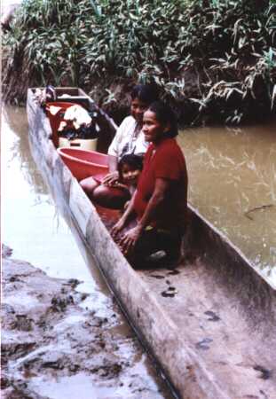 Ladies washing from within a canoe