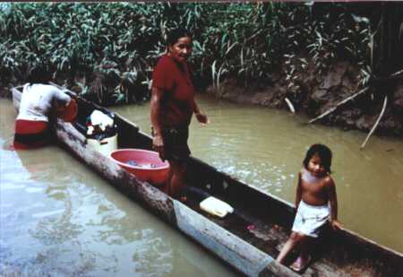 Ladies washing from within a canoe