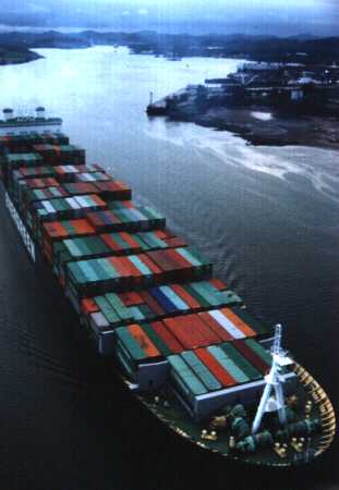 Cargo ship passing under the bridge